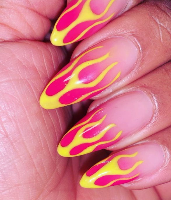 gradient pink nails with yellow flames