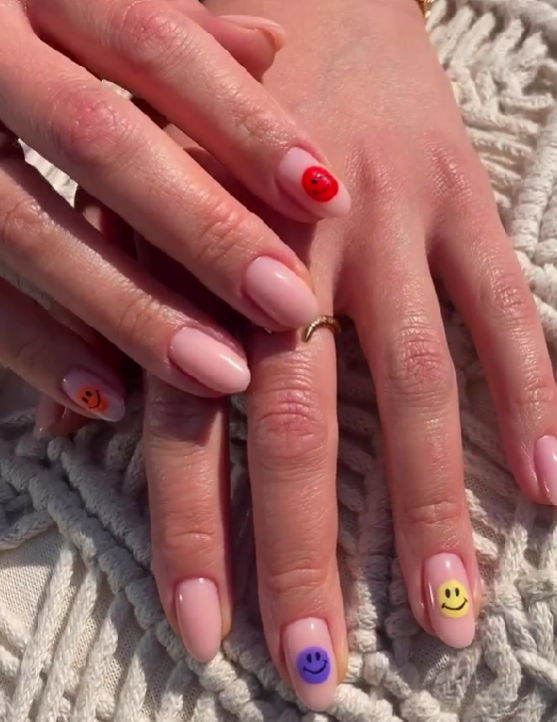 nude nails with colourful smiley faces