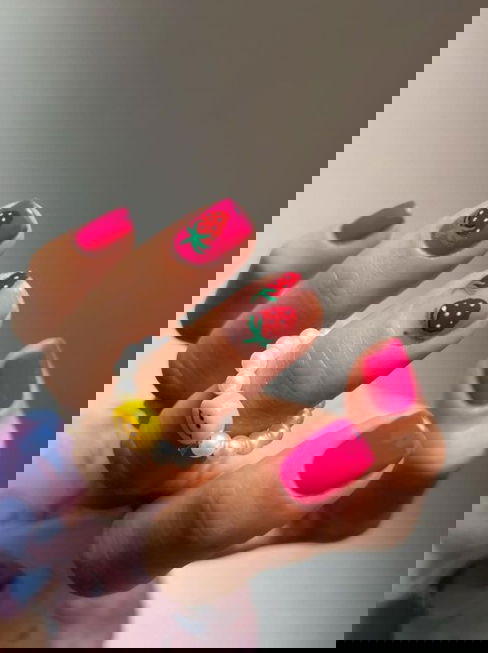 short pink nails with strawberry nail art