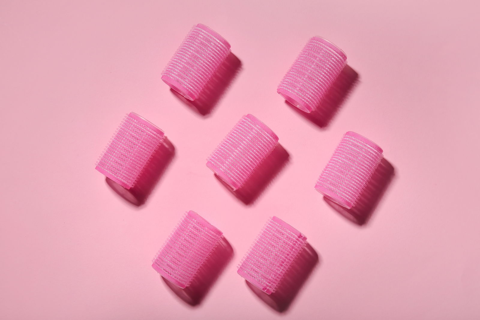 Set of hair curlers on pink background | Live That Glow Your Complete Guide To Use A Curling Iron On Short Hair