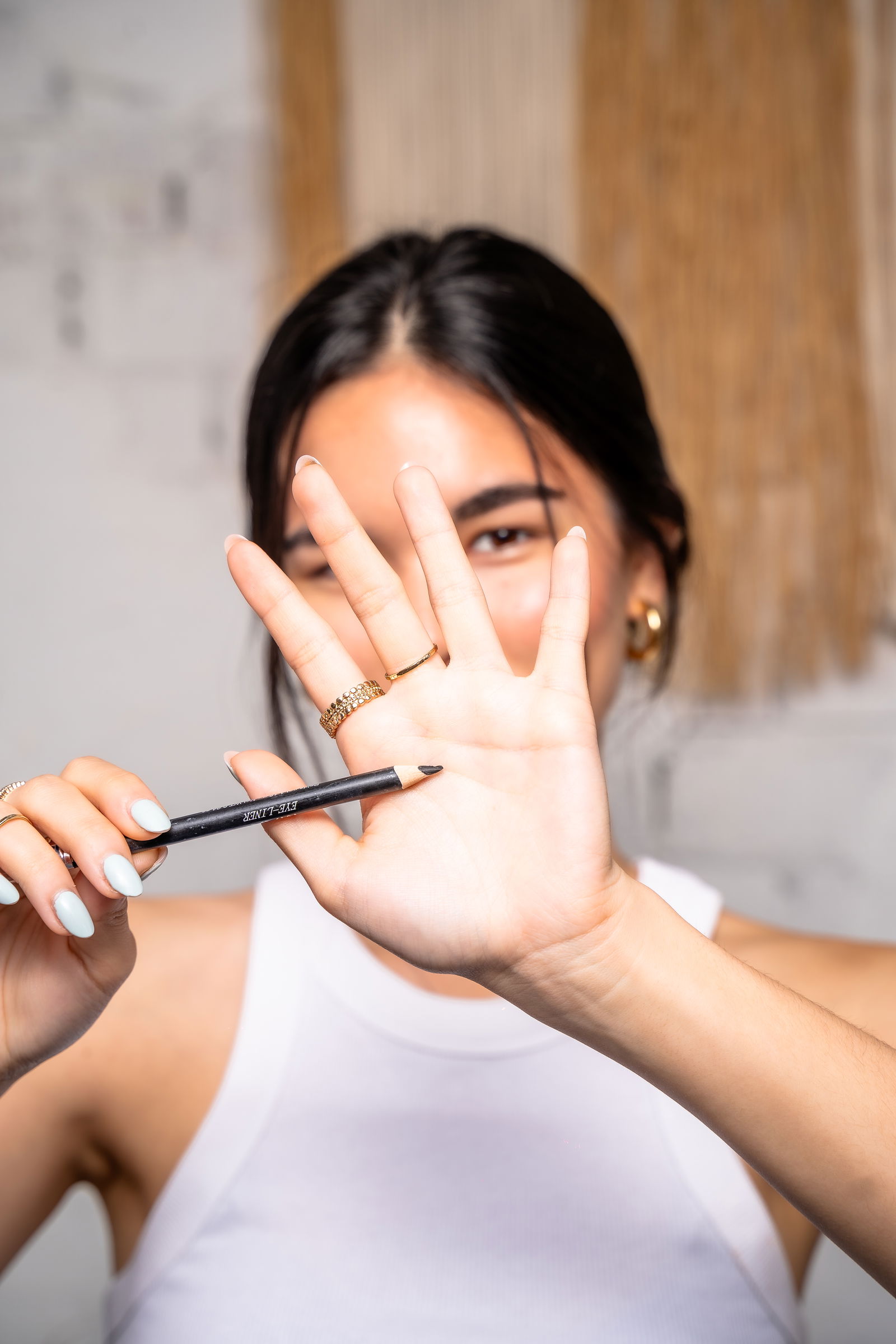 Liner pencil being used in winged eyeliner tutorial 