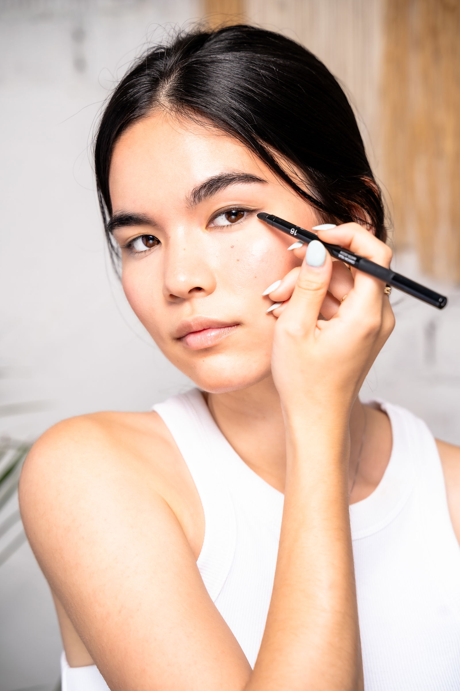 Girl blending out winged eyeliner