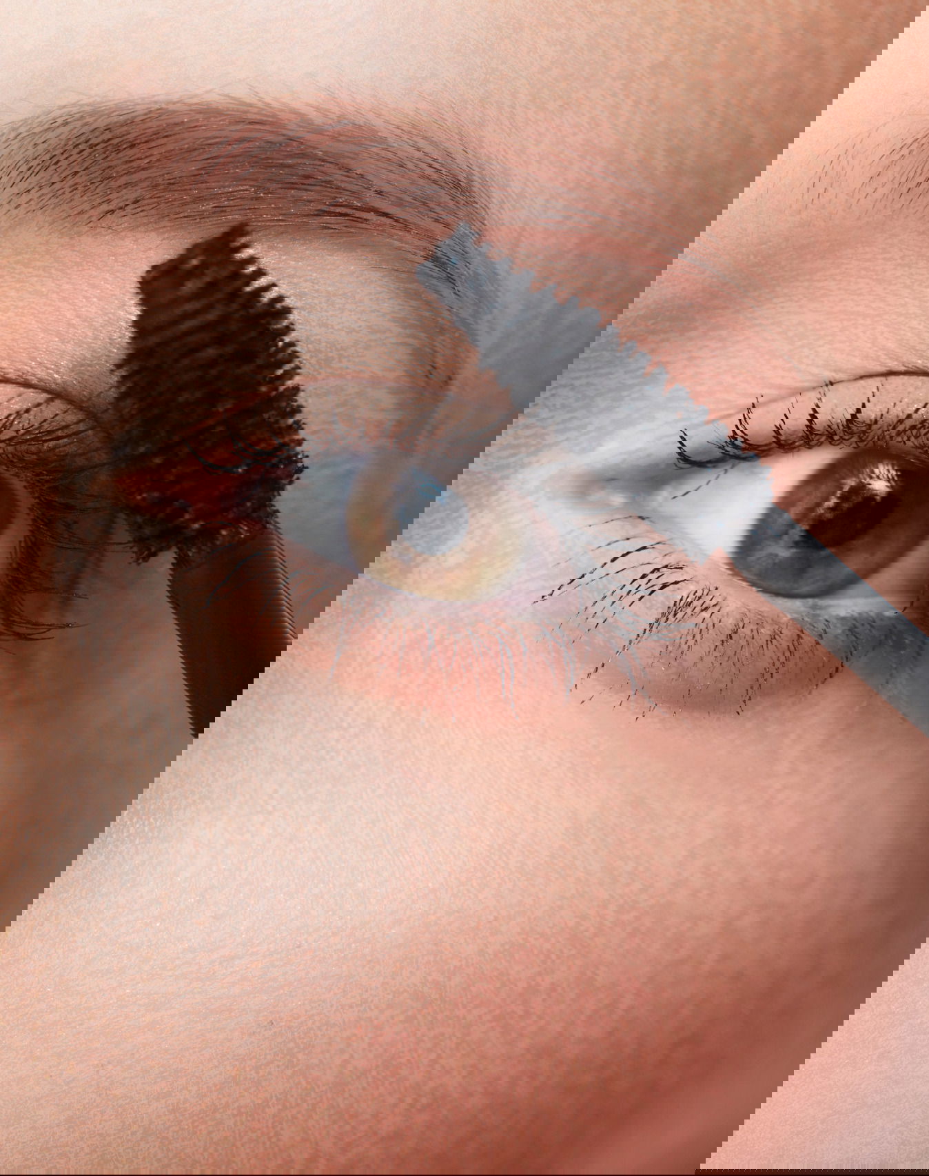 Woman applying mascara