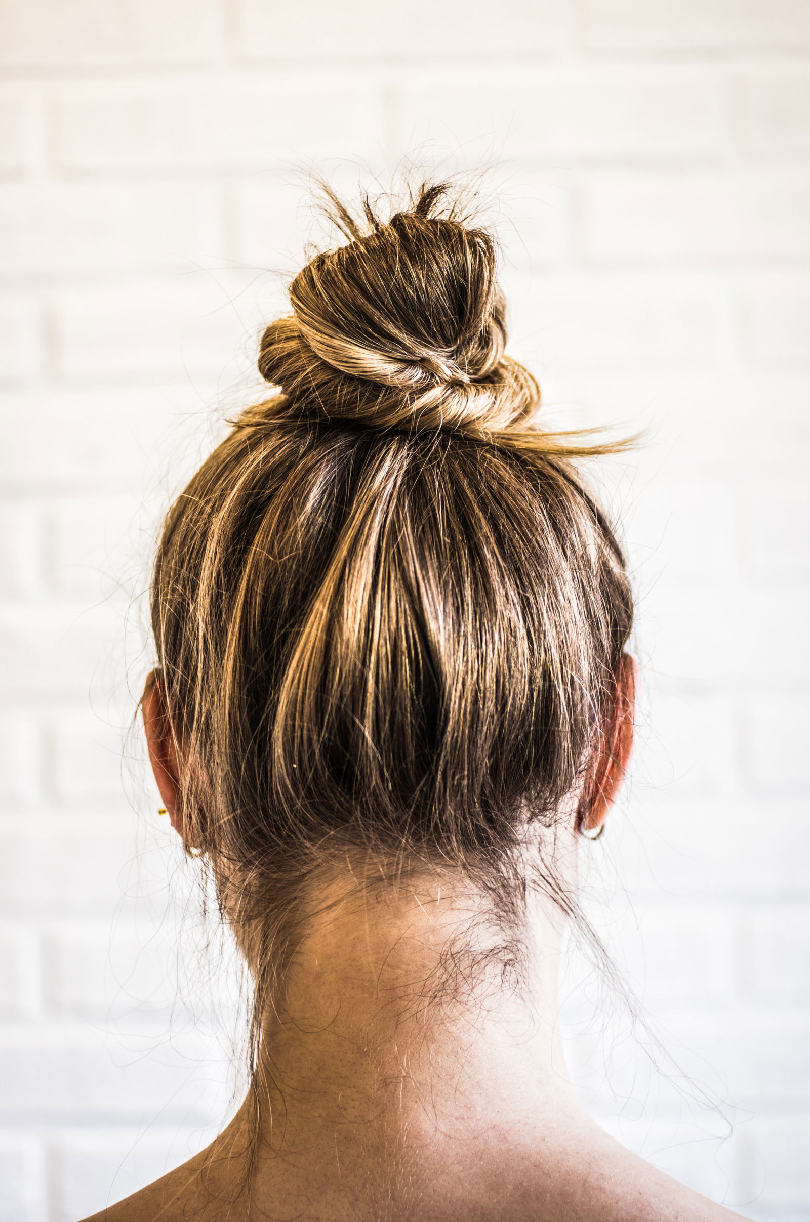 Head of a young woman from behind. Hair bun