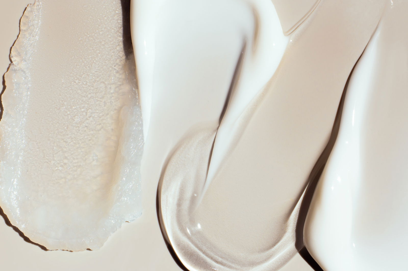 smears samples of various cosmetic textures on a beige background skincare retinol