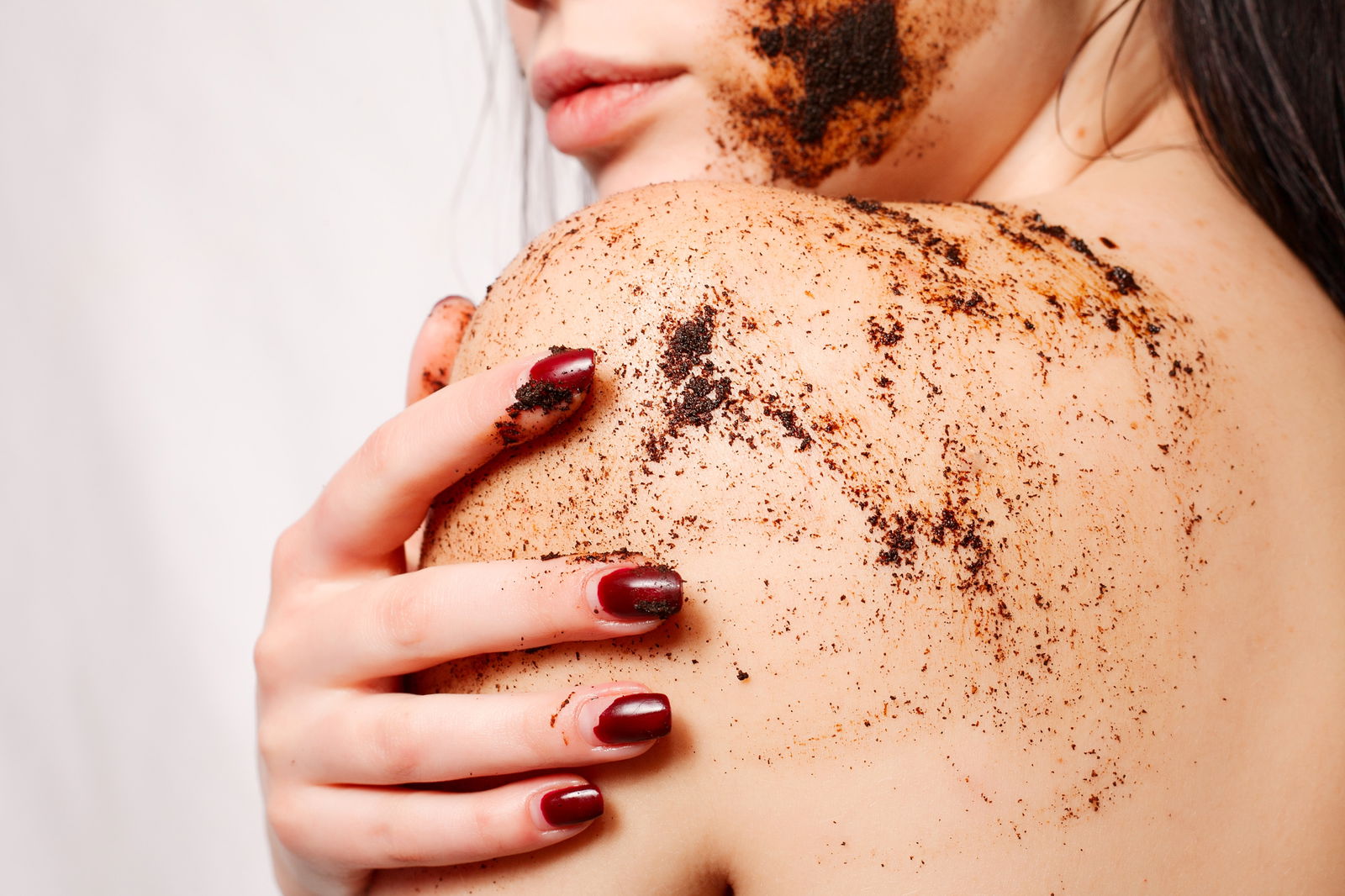 Woman using a body scrub