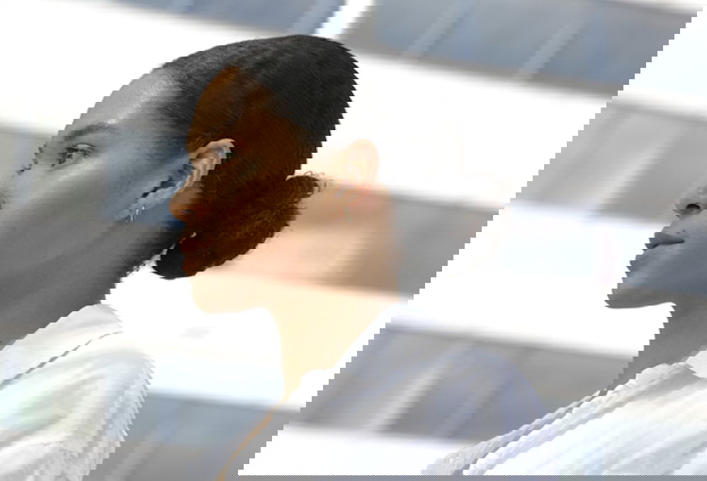 Woman with back and shoulder acne showing the importance of understanding the cause of bacne