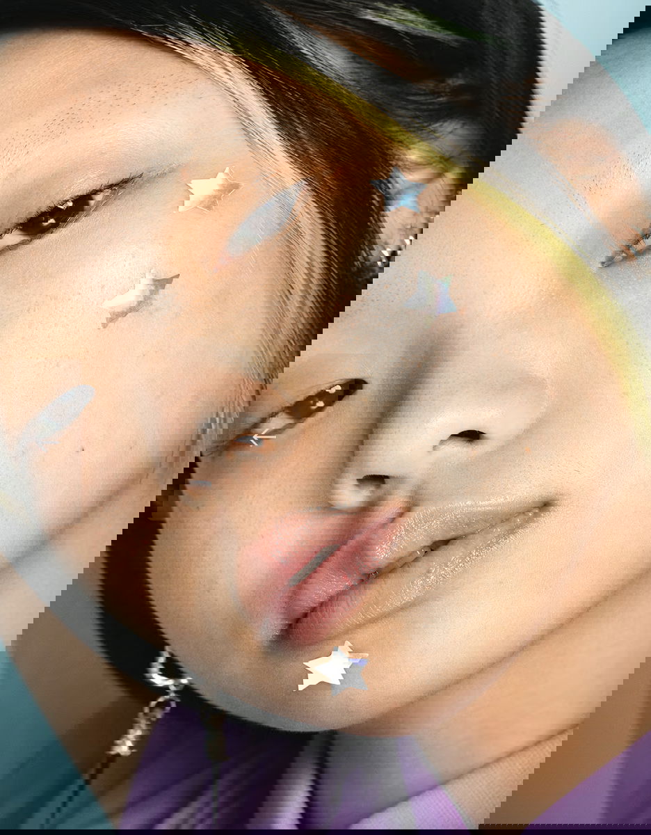 Woman using pimple patch on acne