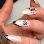 black french tip nails with bug rhinestones
