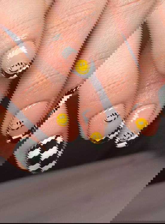 checkerboard gel nails with smiley faces