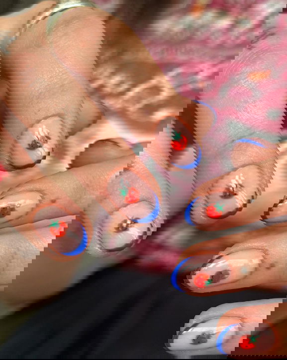 blue french tip nails with tomato nail art