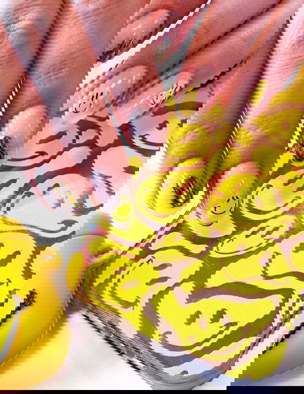 clear nails with yellow and gold smiley faces