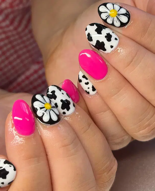 hot pink white and black nails with flowers and cow print designs