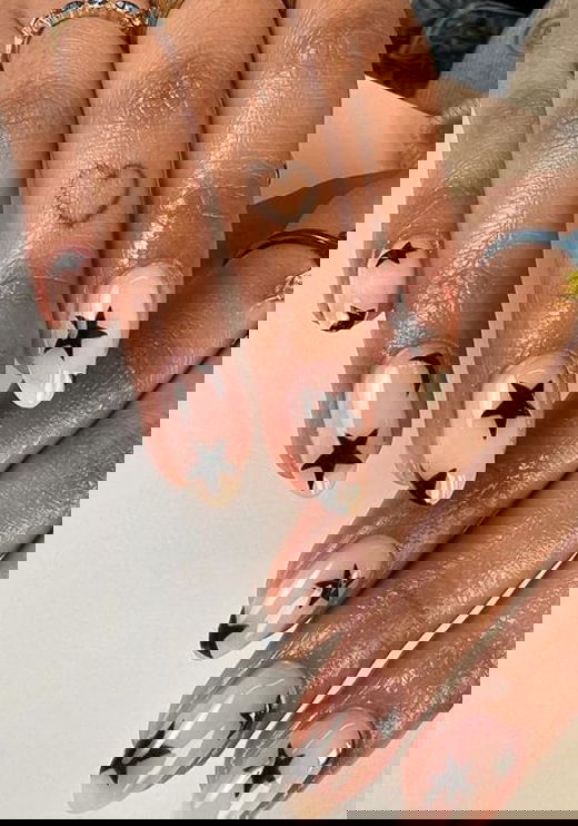 nude almond nails with black stars