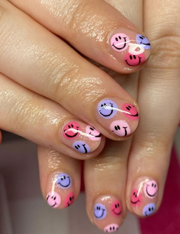 pink and blue smiley face nails