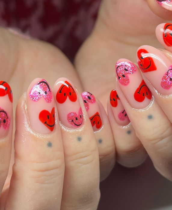 red and pink heart smiley face nails