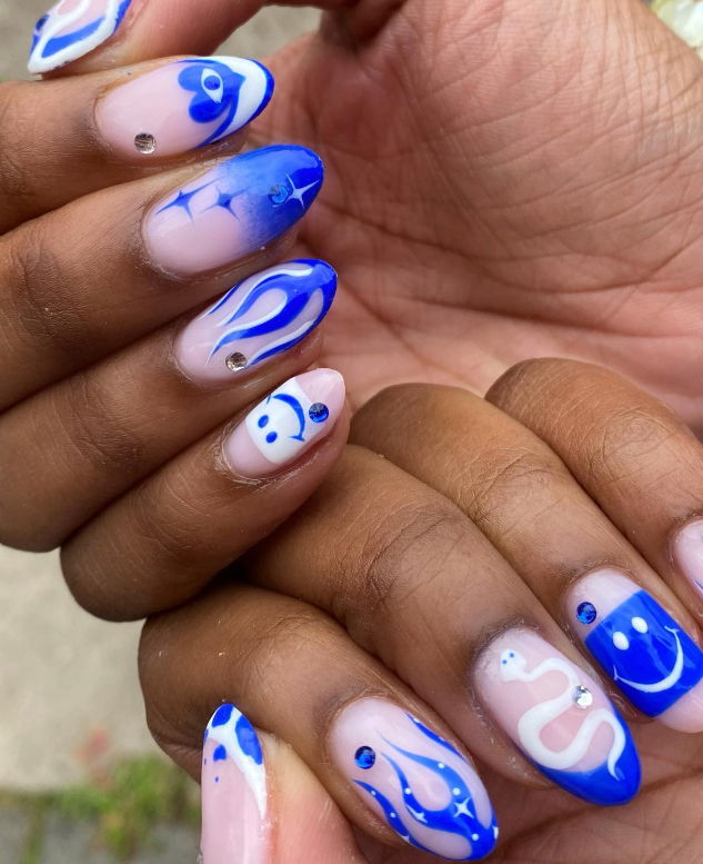 royal blue and white mismatched nails with smiley faces