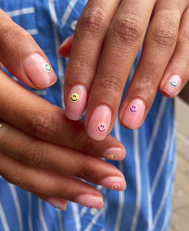 short oval multicoloured pastel smiley face nails