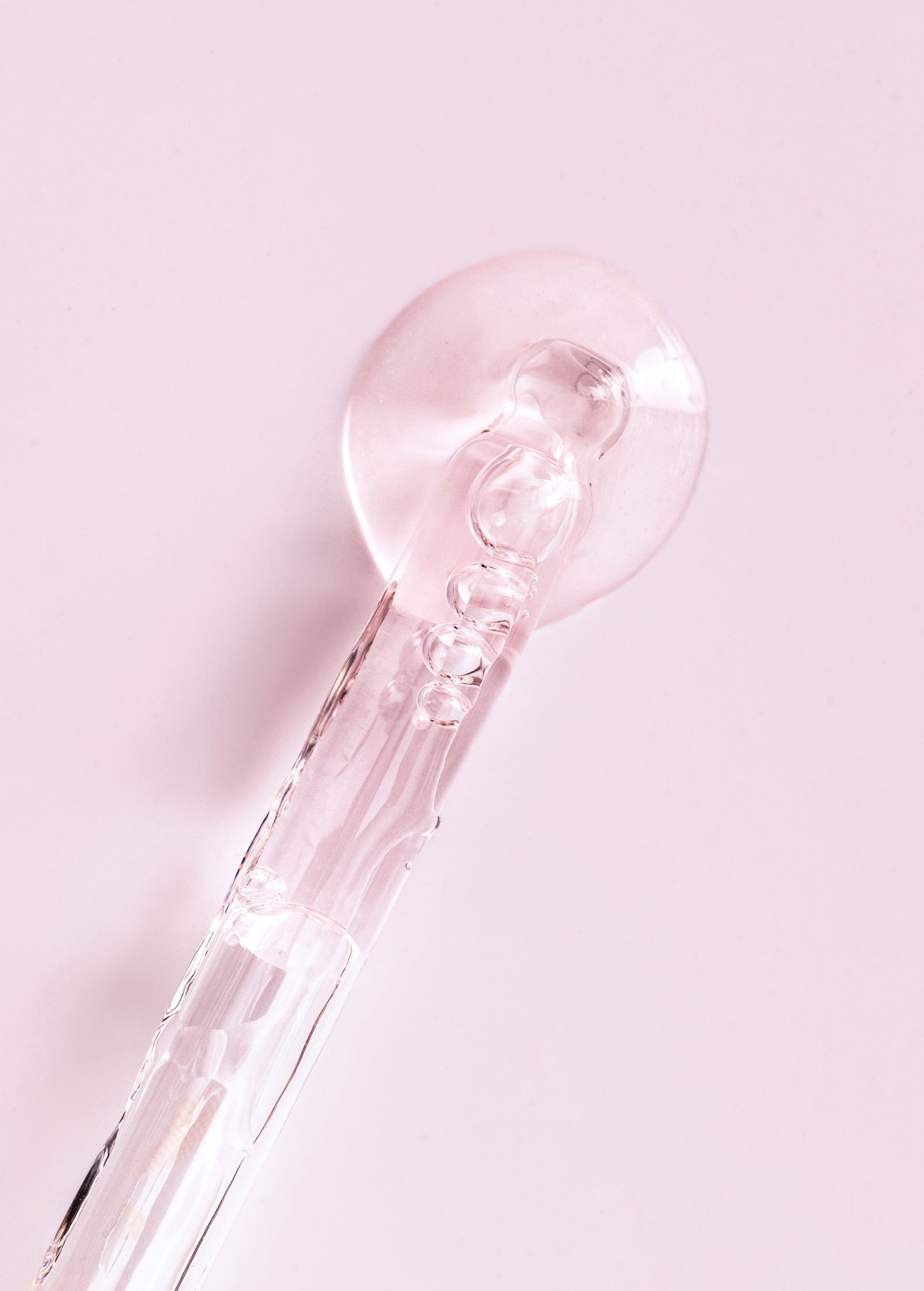 pipette serum closeup on a light pink background | Live That Glow