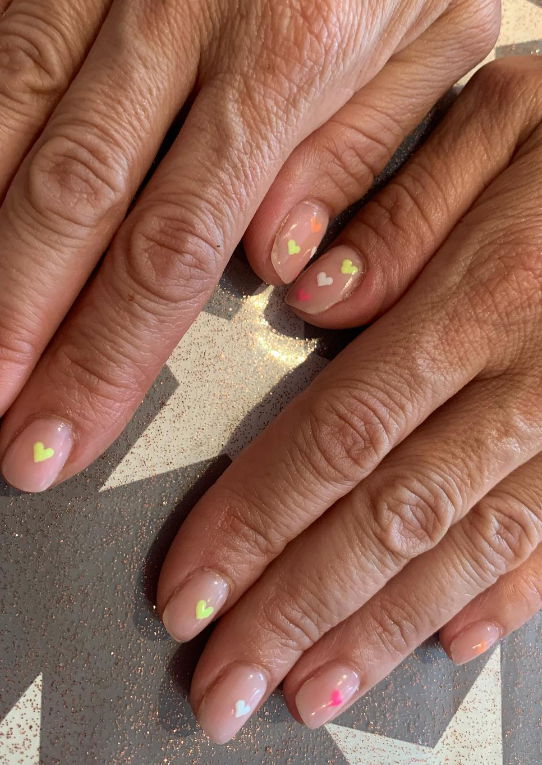 neutral nails with tiny hearts spring