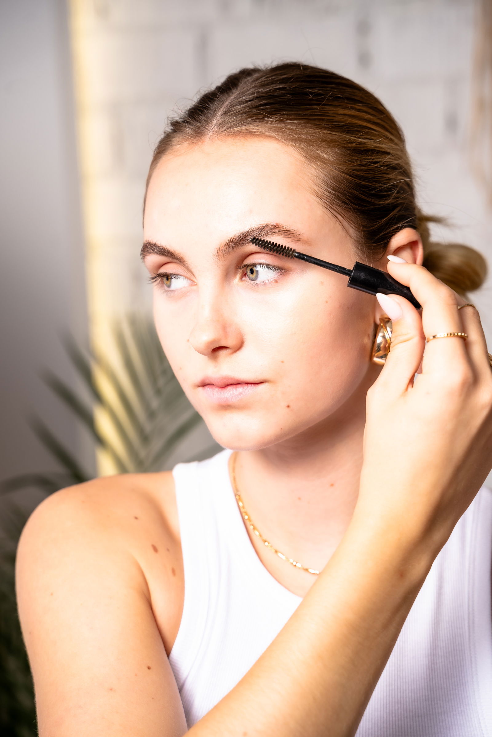 Girl showing how to use brow gel on eyebrows