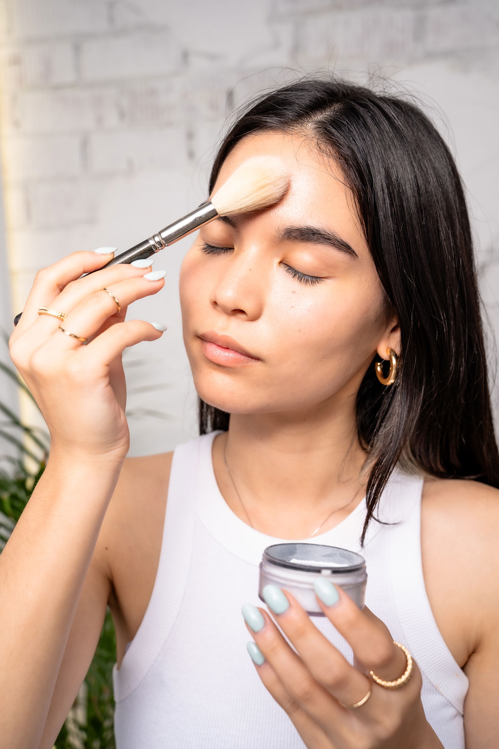 Girl showing how to apply makeup powder to T-zone