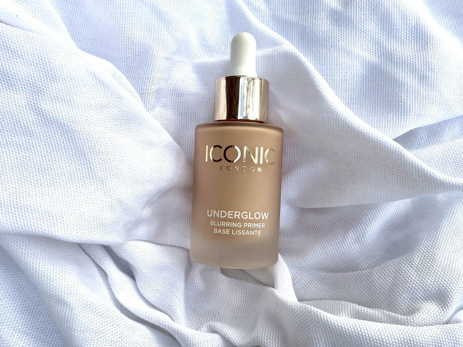 Iconic London Underglow Blurring Primer bottle on fabric